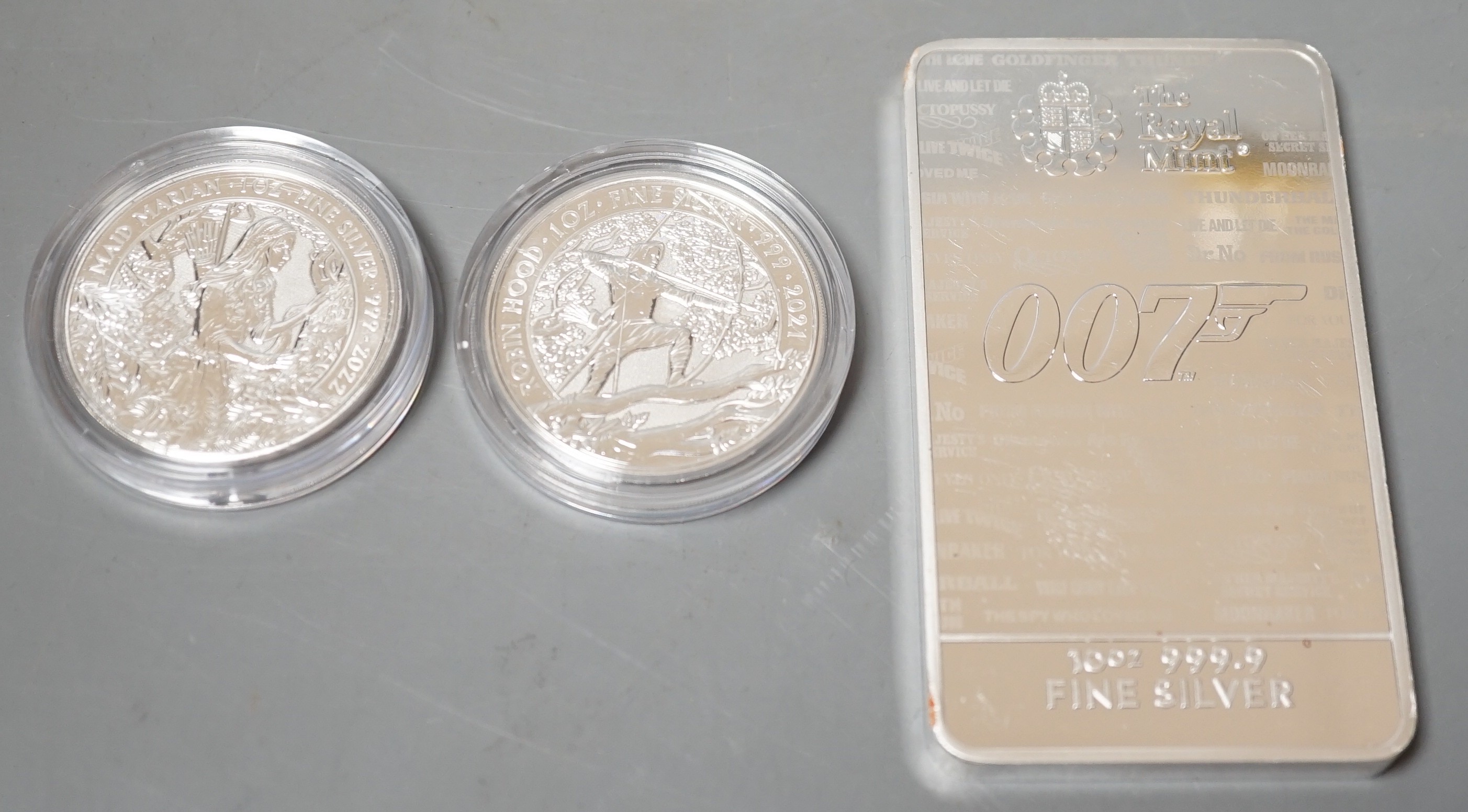 A Royal Mint 10oz Fine silver 007 ingot and two QEII 1oz proof silver £2